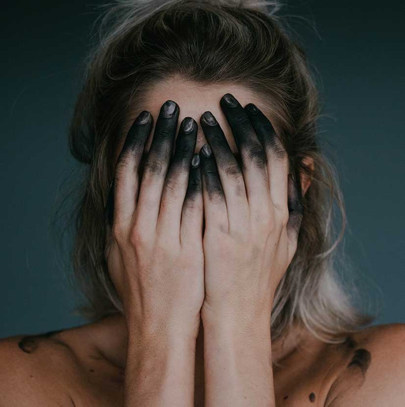 Woman with Black Fingers Covering her Face Woman with Black Fingers Covering her Face